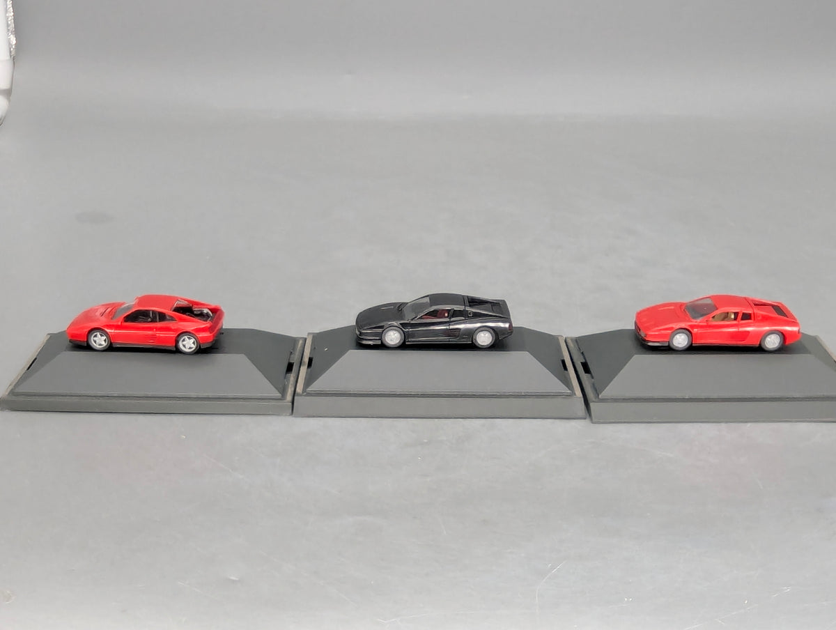 Modellautos 1:87 Herpa Ferrari 3-tlg Set 2x rot, 1x schwarz mit Vitrinen